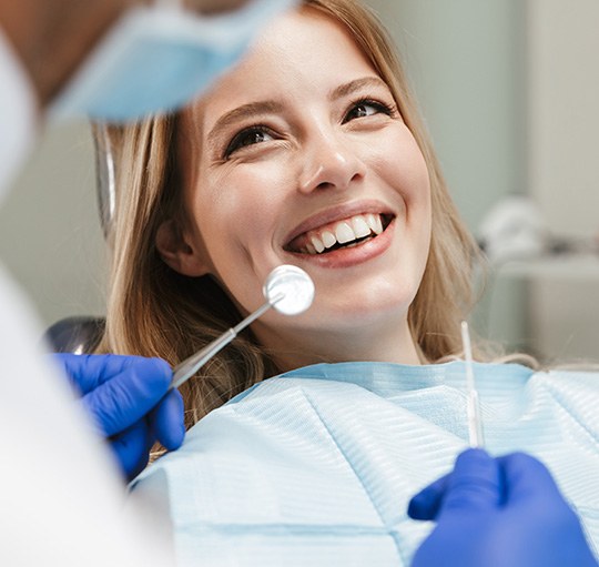 Dentist holding cleaning implements