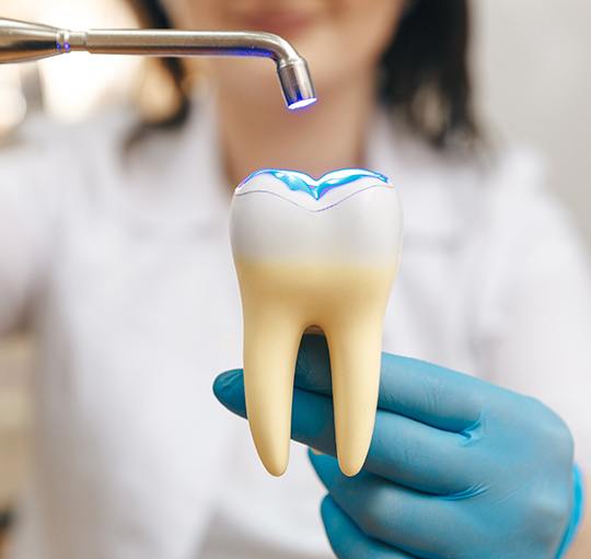  Closeup of dental mirror reflection a woman’s upper teeth